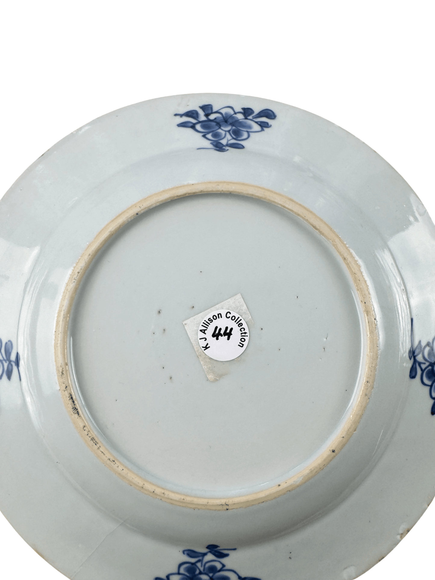Bottom view of the antique Chinese blue and white plate from the K J Allison Collection, featuring floral designs.