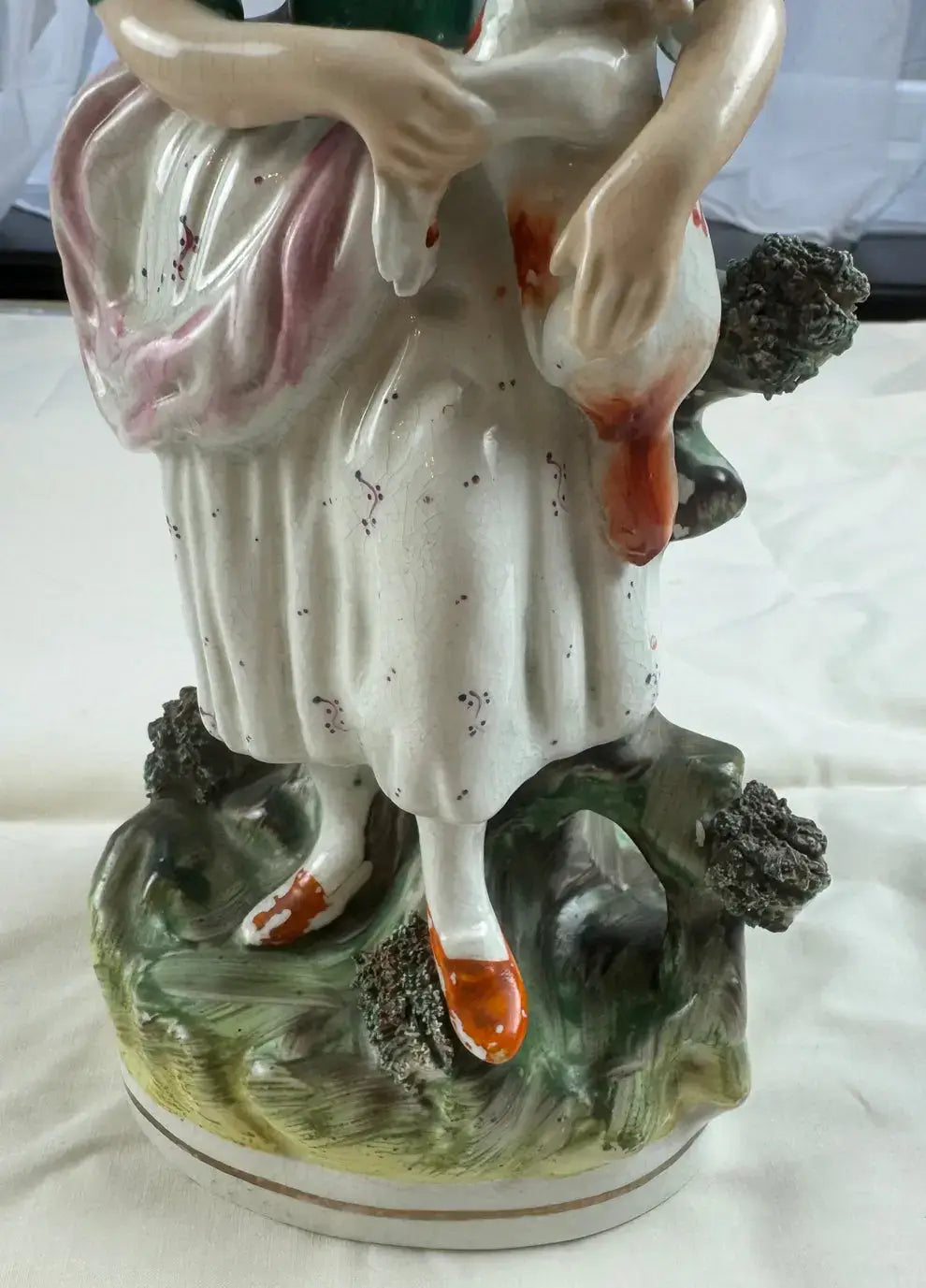 Exquisite 19th Century Staffordshire figurine of a woman in yellow bonnet with a cat, detailed floral base.
