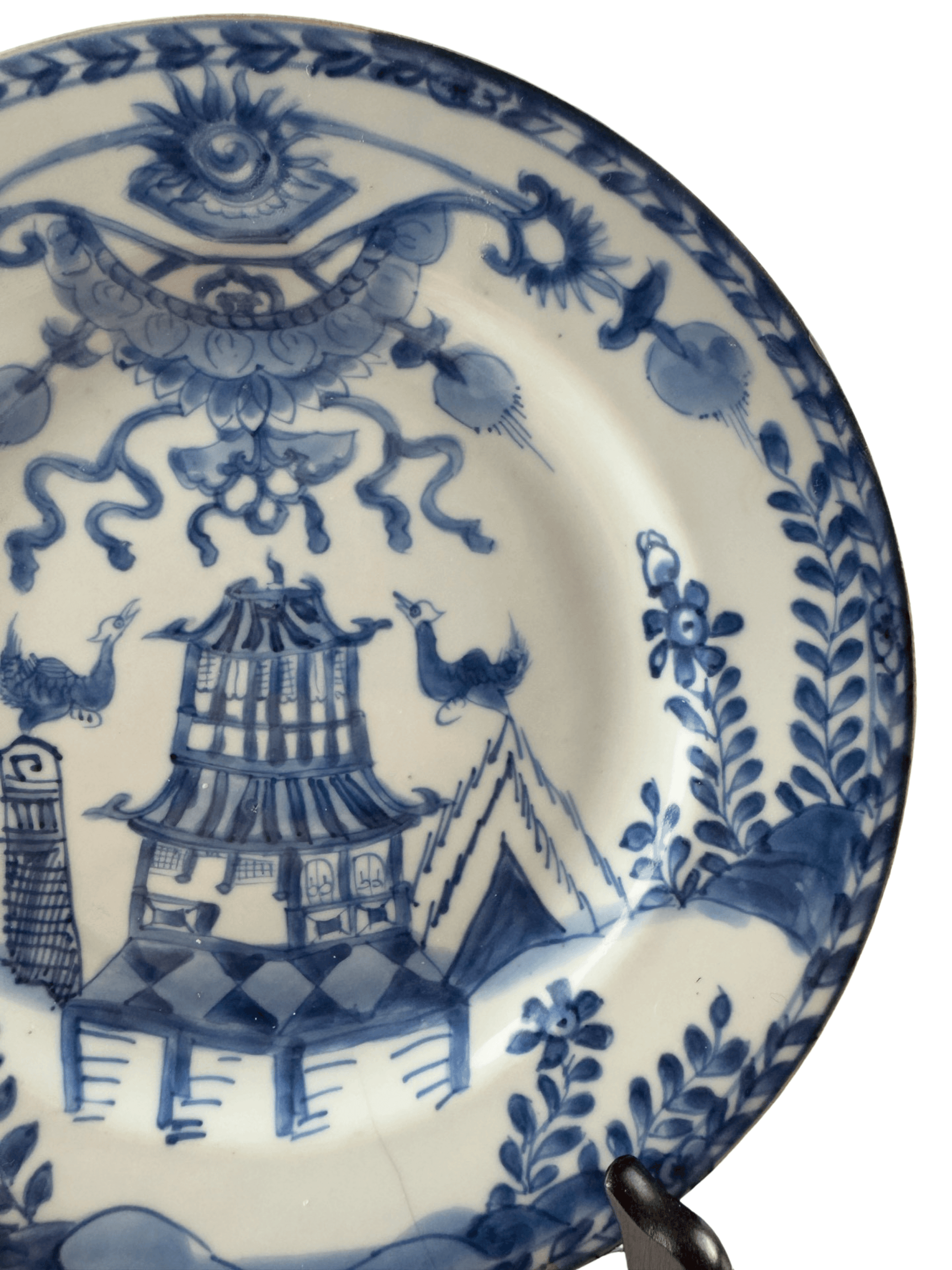Antique Chinese Qianlong blue and white plate featuring a building and birds with intricate floral details.